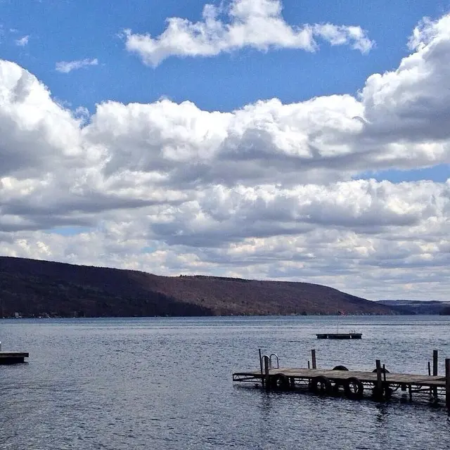 Peaceful scene with Keuka Lake stillness and clouds.