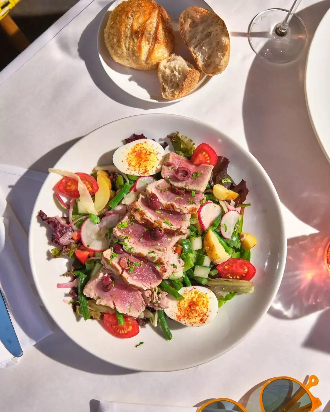 Salade Niçoise with grilled marinated tuna loin, tomatoes, haricots vert, olives, and hard cooked egg